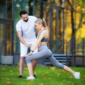 Fitness. Personal Trainer Takes Notes While Woman Exercising Outdoor