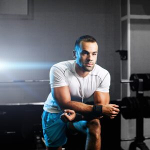 handsome fitness trainer in gym