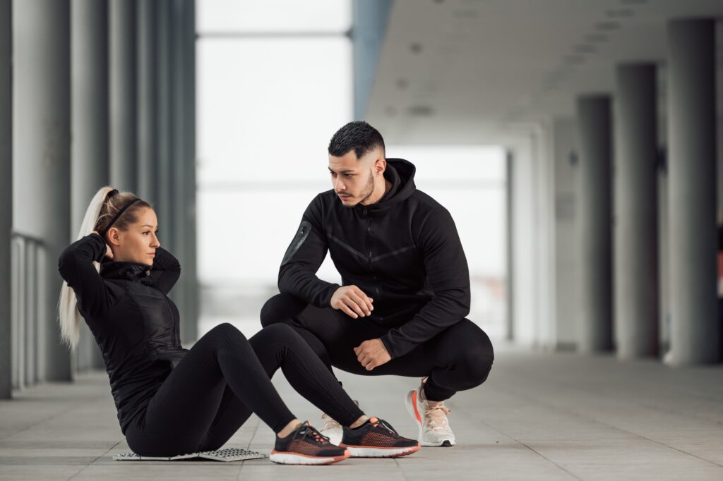 Woman having personal trainer.
