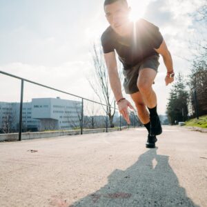 Young sportive man outdoors training running