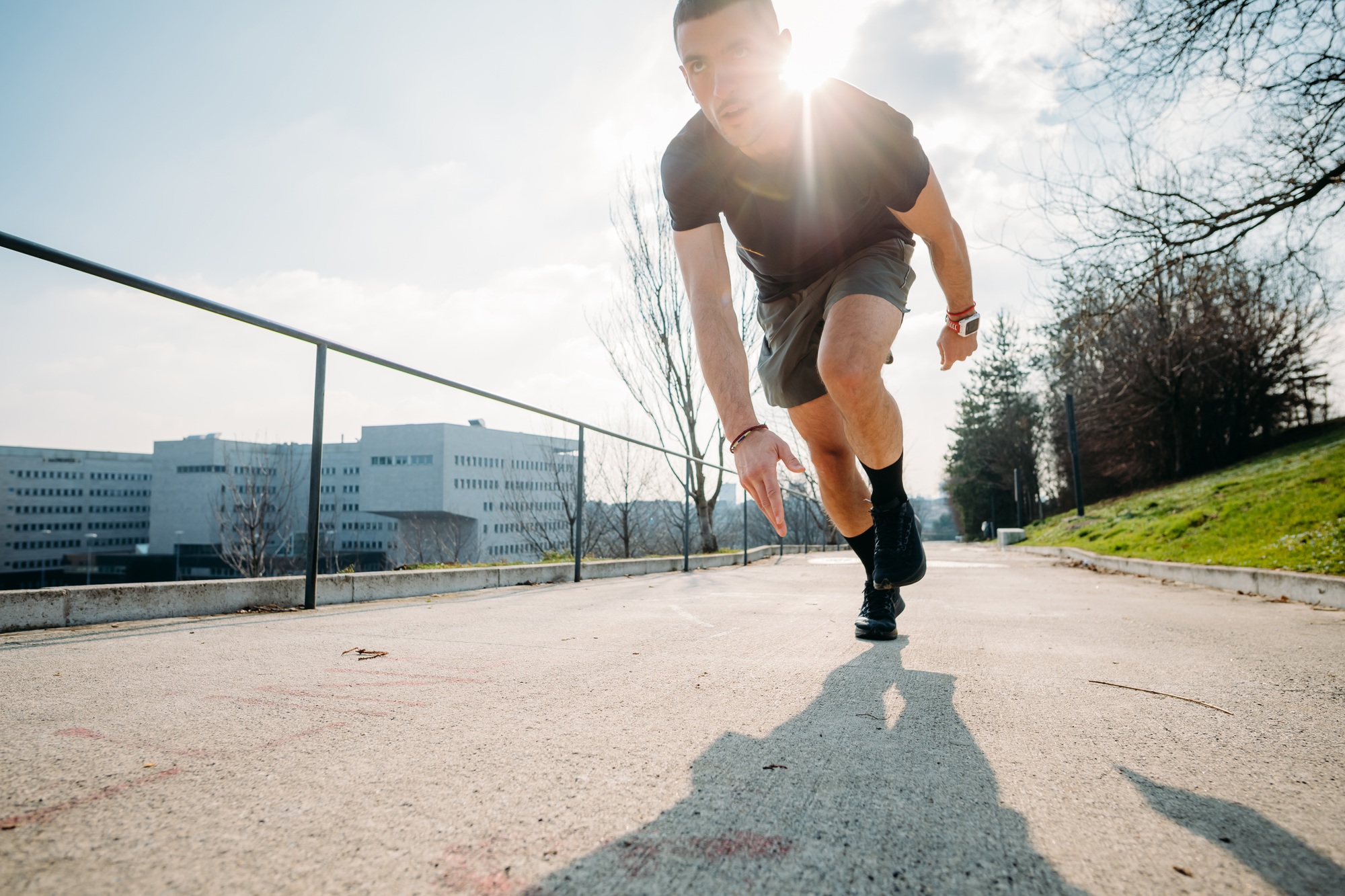 Young sportive man outdoors training running